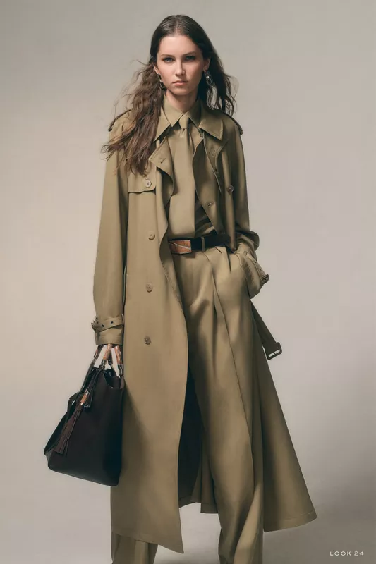 Элегантный оливковый тренч с рюшами и широкими брюками, дополненный стильной сумкой, подчеркивает уверенность