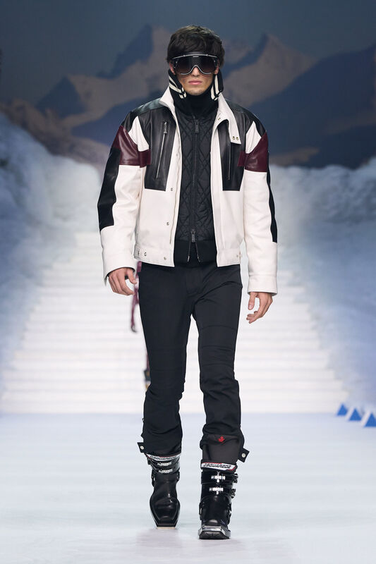 Стильная куртка с контрастными вставками и защитные очки создают эффектный спортивный лук для зимних приключений.