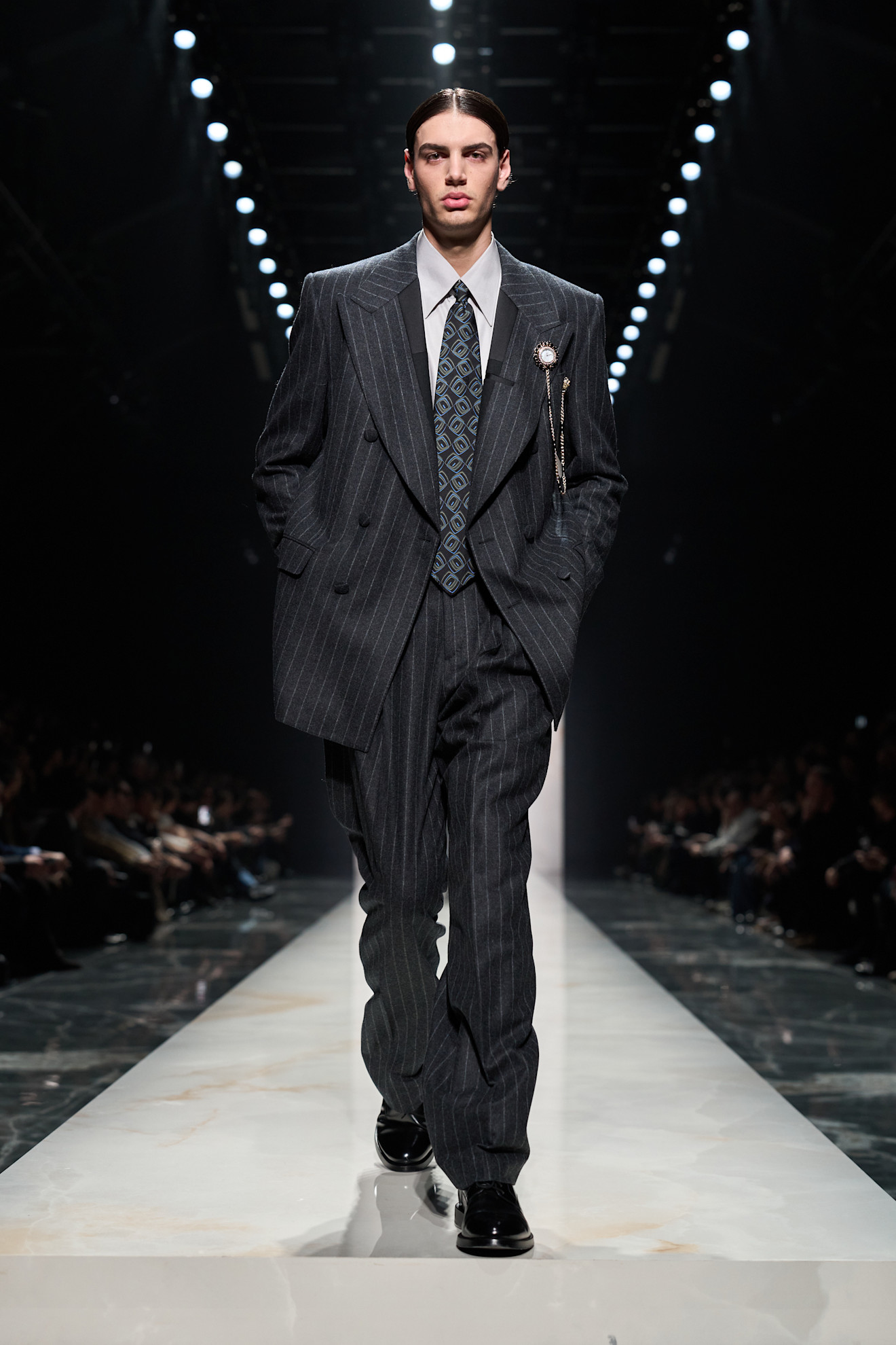 Двубортный пиджак в тонкую полоску с ярким галстуком, создающий эффектный контраст с классическим стилем