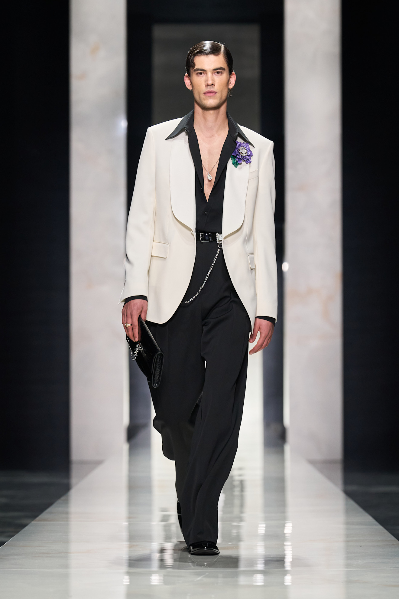 Элегантный образ в белом пиджаке с черным воротником, черная рубашка и стильные аксессуары создают атмосферу утонченности