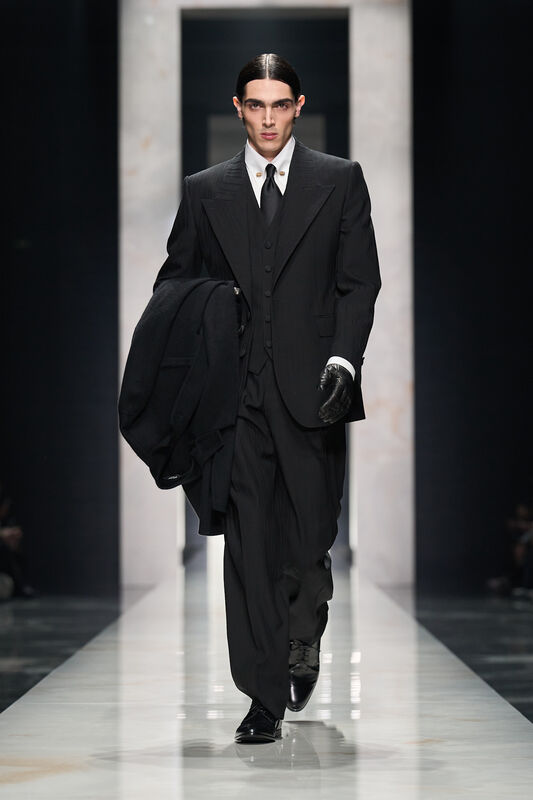 Элегантный черный костюм с жилетом и классической белой рубашкой, подчеркивающий строгость и утонченность стиля