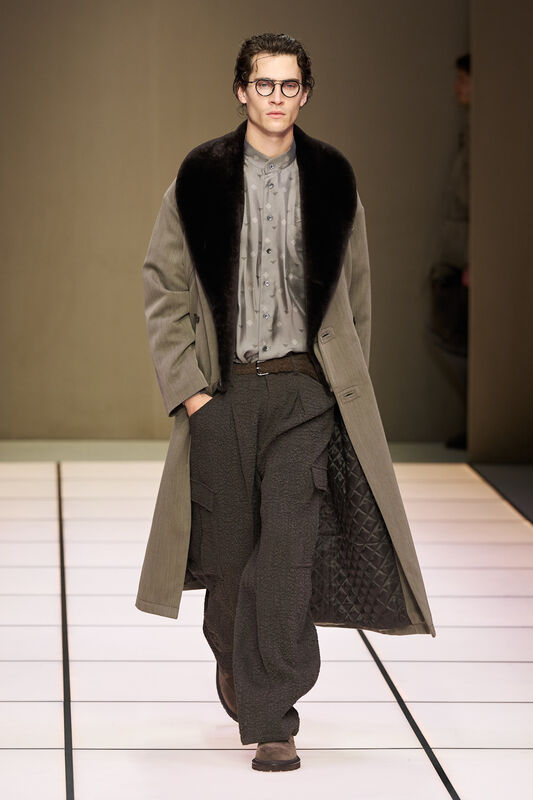 Стильный образ в сером пальто с меховым воротником и объемными брюками, создающий атмосферу утонченной элегантности