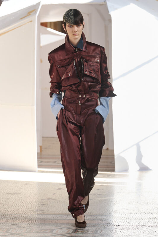 Лаконичный комбинезон бордового цвета с объемными карманами и контрастными рукавами, подчеркивающий силуэт модели