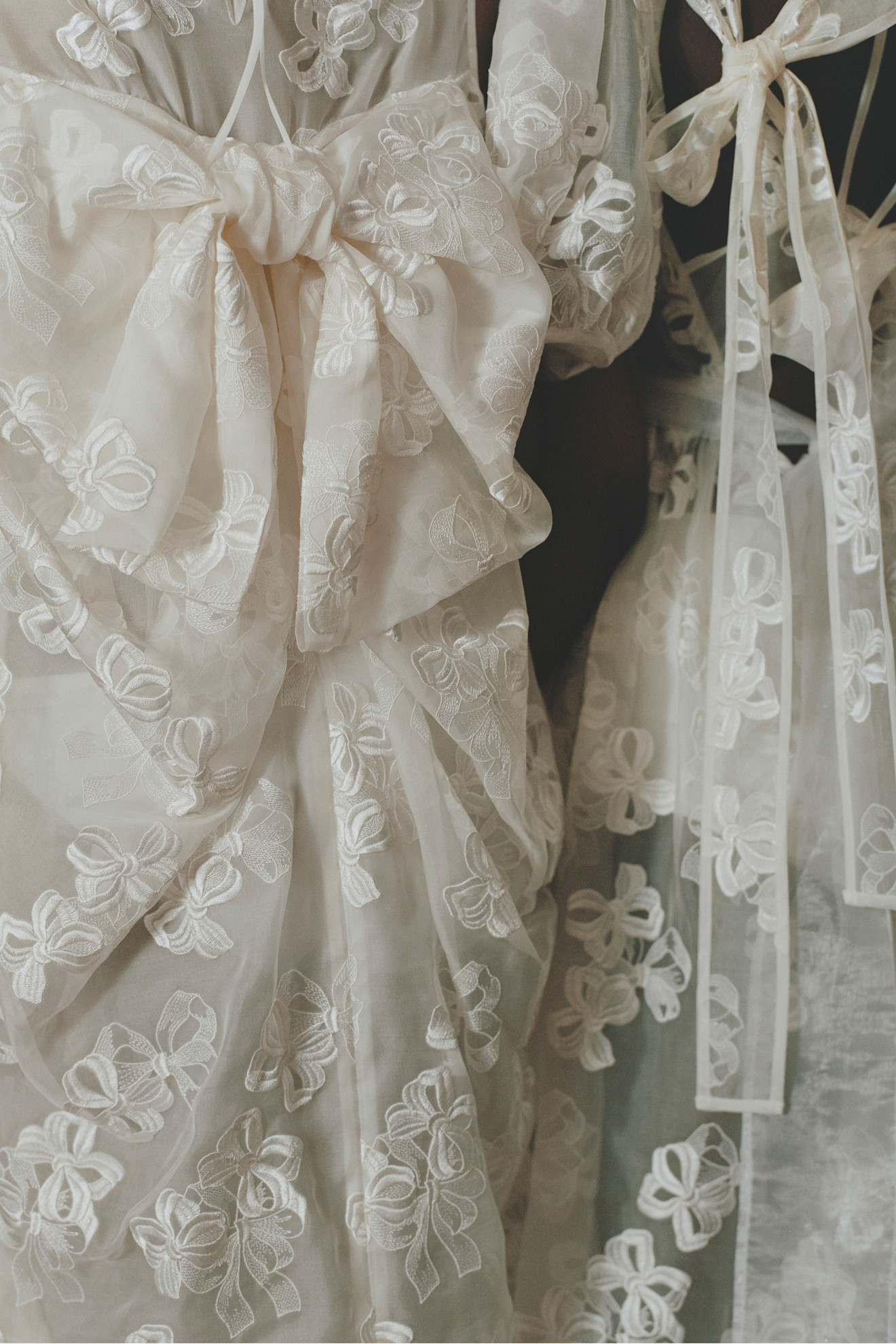 Элегантные платья с объемными белыми бантами и цветочной вышивкой, подчеркивающие утонченность и легкость образа