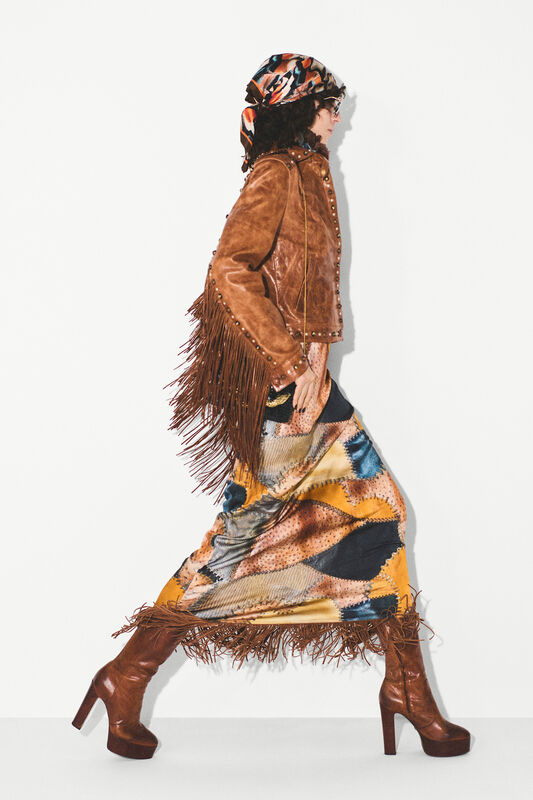 Замшевая куртка с бахромой в сочетании с ярким платьем в стиле патчворк, завершает образ стильным платком