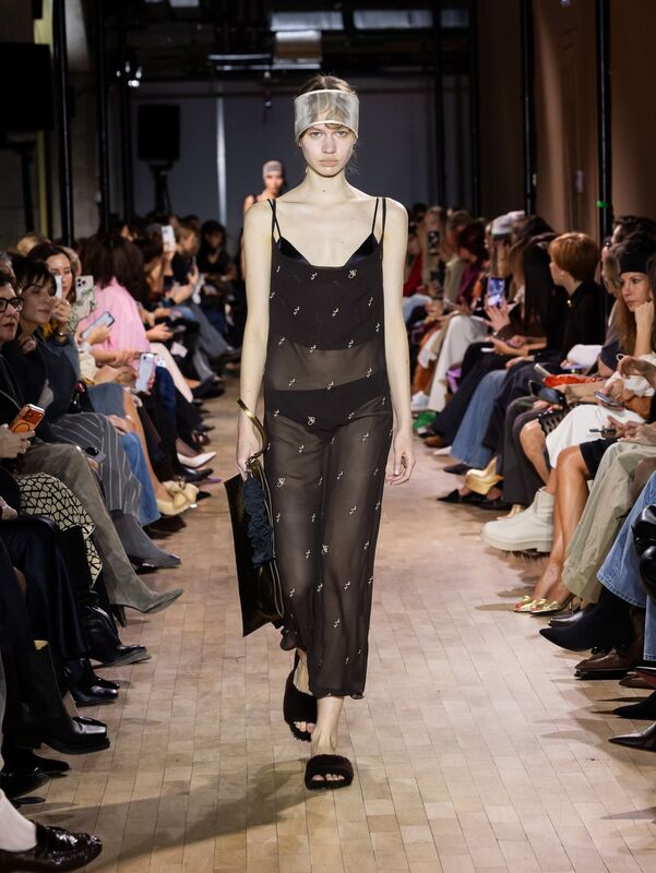 Полупрозрачное черное платье с вышивкой, создающее легкость, в сочетании с шляпкой и уютными сандалиями